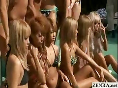 Suntanned group of Japanese teens posture for a topless pool photo shoot