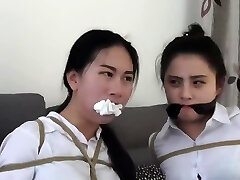 Chinese secretaries in white shirts are scrupulously gagged