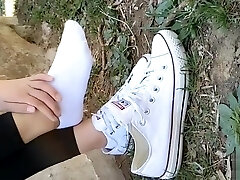 Chinese girl sprains foot in white ankle socks and black stretch pants