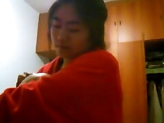 Asian gal with big boobs changes clothes in her bedroom