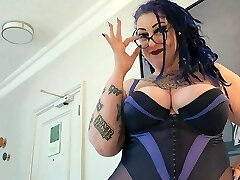 BBW Milf with big bumpers and tattoos gives pierced cock a hand job.