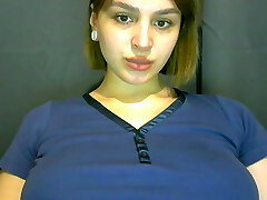 A pregnant chick gets naked and caresses her pussy