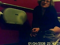 Mature unsuspecting female sitting on a rest room