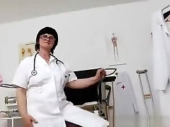 Brunette practical nurse inspecting her vagina