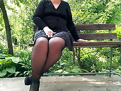 Naughty cougar in pantyhose pissing in the park on a bench – rear sight