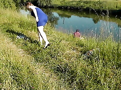 Nudist beach. Public nudity. Sexy Milf without panties and bra sunbathes bare is not bashful about fisherman. Naked in public. Milf