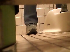 Pissing in the toilet and showing bushy pussy on spy cam