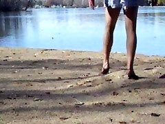 Crossdresser at the lake in hose pipe and heels