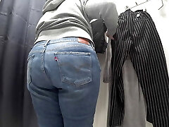 In a fitting room in a public store, the camera caught a chubby milf with a marvelous backside in translucent panties. PAWG.