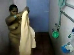 Fat Indian lady washes her body in the bathroom in hidden cam clip