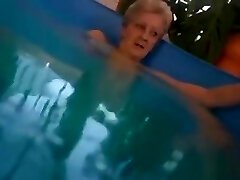 mamie dans la piscine avec gode gonflable