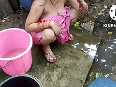 Indian mansion wife bathing outside