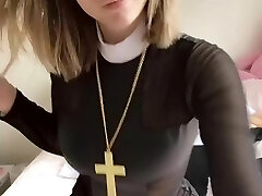 Pious girl with a cross showcases her tits and pussy