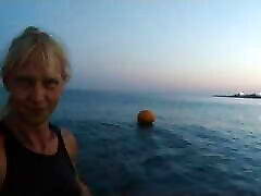 Alexa Cosmic swimming in the sea after sunset in clothes. Wetlook in sneakers, shorts and t-shirt
