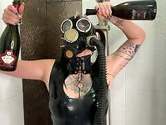 Dominatrix Nika in a gas mask pours wine over her cute girl loving sex body. crossdressr homemade fetish
