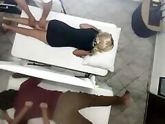 Erotic Massage on the Body of the Beautiful Wife Next to Her Husband in the Couples Massage Salon It Was Recorded