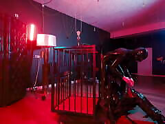 Rubber Nights: the Rubber Slave Rests Tight in a Cage Under the Bed