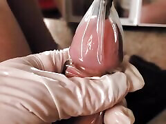 Filling a Condom Full of Cum with Sounding Rod Inserted