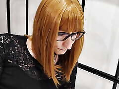Redhead trans girl in nylons resting and playing with her legs.