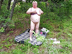 Neighbor undressed in a public park and masturbates her big pussy