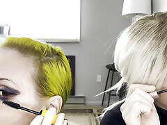 Man and Woman Putting on Mascara and Fake Lashes