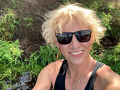 Trans girl Alexa Cosmic swimming and playing in the lake wearing black short and blue top