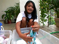Kat Young is washing her clothes in front of cam outdoor