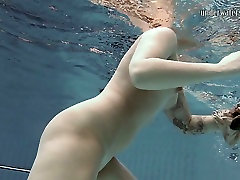 Tattooed girl Sara Bombina swimming in a pool naked