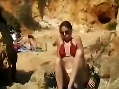 Dark Brown beauty disrobes off her bikini and masturbates at the beach