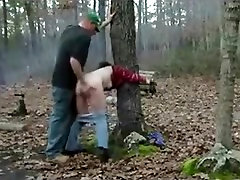 Redneck slut, tied to a tree in the forest, gets doggystyle fucked.