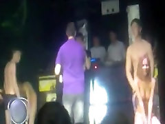 2 russian couple have a esma poren game on stage in a disco