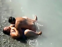 Voyeur busts a bbw with huge tits fucking in the sea