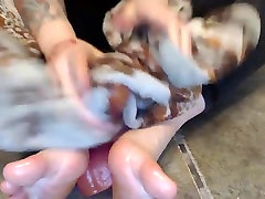 Sexy Tattooed Woman gives footjob to her Toy