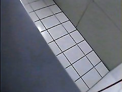 A blonde is dildo play for the camera in the college toilet