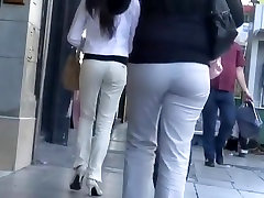 Woman in princesss mackayla pants walks on the street in front of the spy cam