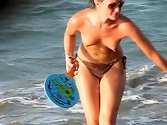 Voyeur films babes with naked tits playing on the beach