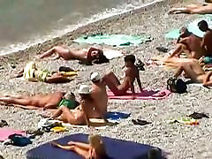 Muscular men and sleek women on a nude beach candid video