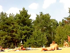 Naked people enloyong the sun on the beach