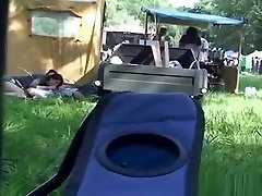 Drunk girl having dildo insertion pussy contest with a boy under a tent