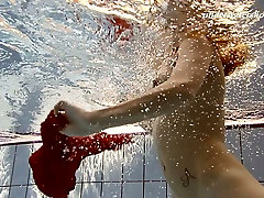 Sensual red haired babe Ala shows striptease under the water