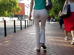 Slim woman s ass in white pants
