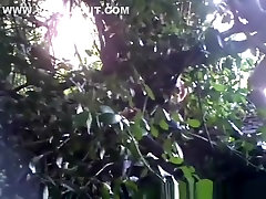 Woman caught beyond some bushes peeing