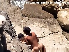 Couple spied in rocky beach having sex