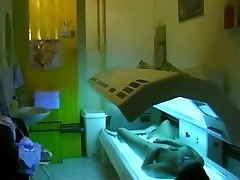 Teen girl fingers remote control fight during tanning