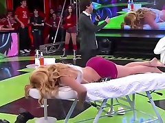 Athletic lady receives a massage live on the television