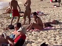 Topless girl on the beach has a nice booty