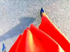 POV women big bosts in a flared orange skirt and heels