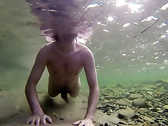 Boy swiming naked in the water