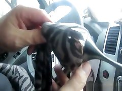 Blonde milf using her high heels to masturbate in the car