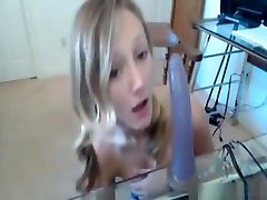 starding sex blonde in a sexy outfit has fun with a toy